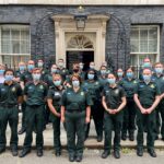 A group of medics in LAS uniform stood outside the door to 10 Downing Street