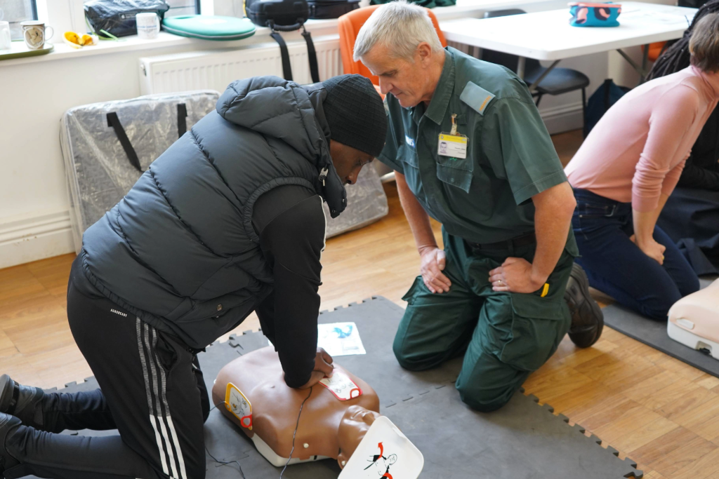 CPR being taught at a community event space.