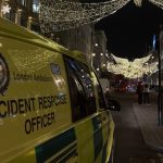 An Incident Response Officer vehicle on Oxford Street with festive lights visible in the distance.